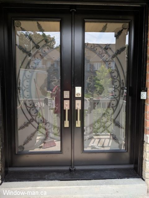 Front exterior doors. Double entry steel insulated. Professionally painted black. Full wrought iron glass inserts. Forest King Lions iron glass design